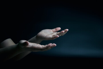 Symbol by hand. supplication and faith, intercession, encouragement gesture of male hands on black background with copy space