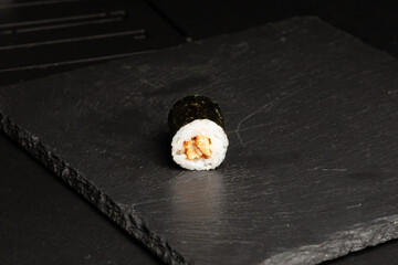 Traditional japanese nigiri sushi, separated on black stone background