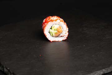 Traditional japanese nigiri sushi, separated on black stone background