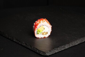 Traditional japanese nigiri sushi, separated on black stone background