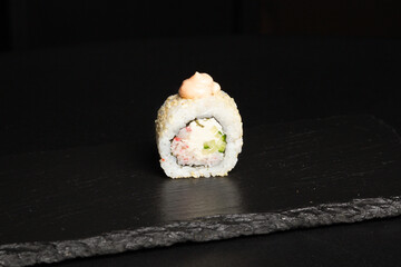 Traditional japanese nigiri sushi, separated on black stone background