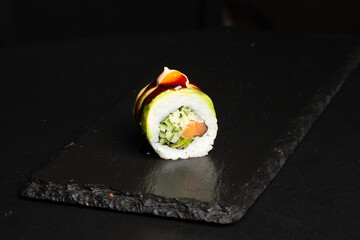 Traditional japanese nigiri sushi, separated on black stone background