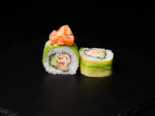 Traditional japanese nigiri sushi, separated on black stone background