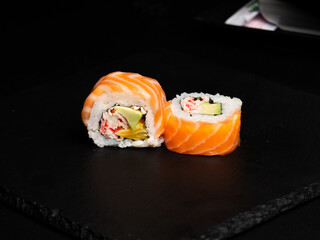 Traditional japanese nigiri sushi, separated on black stone background