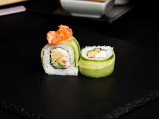 Traditional japanese nigiri sushi, separated on black stone background