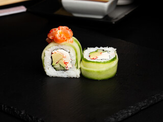 Traditional japanese nigiri sushi, separated on black stone background