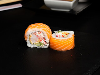 Traditional japanese nigiri sushi, separated on black stone background
