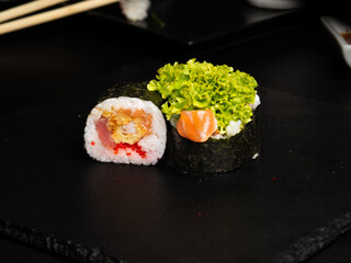 Traditional japanese nigiri sushi, separated on black stone background