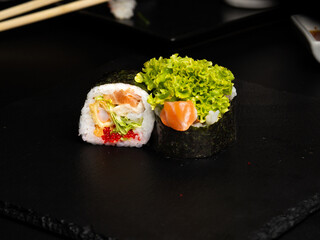 Traditional japanese nigiri sushi, separated on black stone background