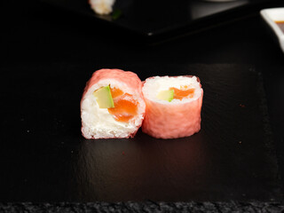Traditional japanese nigiri sushi, separated on black stone background