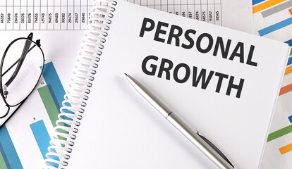 PERSONAL GROWTH , pen and glasses on chart, business concept