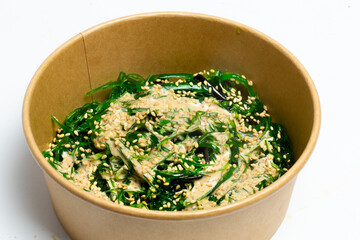 Poke bowl with raw salmon, rice and vegetables on white background