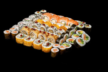 Traditional japanese nigiri sushi, separated on black stone background