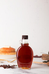 Beautiful maple syrup in a bottle. Maple leaves
