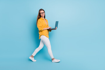 Fototapeta na wymiar Full length profile side photo of young business woman happy positive smile go step meeting laptop isolated over blue color background