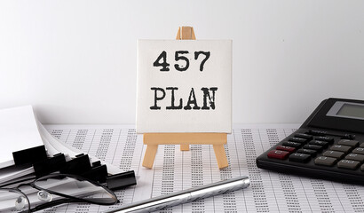 text 457 plan on easel with office tools and paper.Top view. Business concept