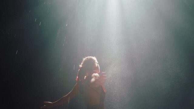 beautiful woman dancing in waterfall cave wearing beautiful dress enjoying dance feeling spiritual freedom 4k
