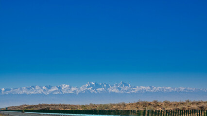 In the distance, the mountains are covered with snow.