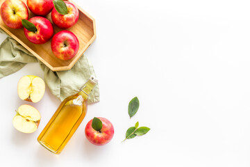 Fototapeta na wymiar Bottle of organic apple cider vinegar with red apples