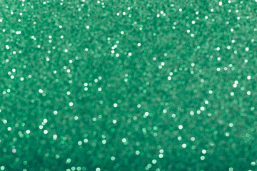Green glowing sequins blurred background
