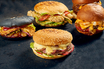 Different types of burger on a dark background. Burger set