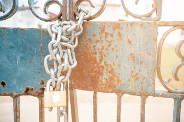 Metal chain and padlock on sunset background.Closed shops for COVID-19 disease global pandemic outbreak. 