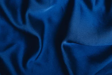 Poster Dark blue fabric laid in soft folds © Ольга Голубева