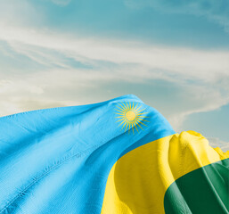 Rwanda national flag cloth fabric waving on the sky with beautiful sun light - Image