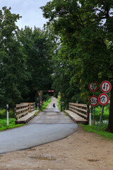 a man walks across the old bridge