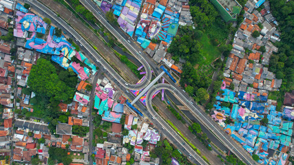 Aerial view of infinity sign traffic junction cross 'Jakarta a city of collaboartion' road with car transport. Jakarta, September 2, 2021
