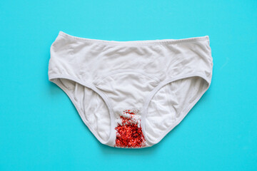 Menstruation period panties with red sparkles on the blue background