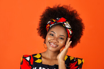 cute african young woman in traditional dress on red background 