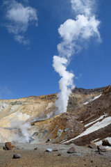 When climbing the Mutnovsky volcano, you can observe the release of steam of boiling water on the glacier. Kamchatka Peninsula, Russia