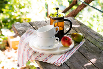 Breakfast serving for two, tea cups and fruits