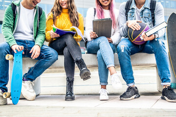 Students doing group project sitting in university campus - Back to school concept
