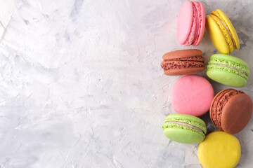 Macaroons on a light background. Sweet French cake, different types of macarons.