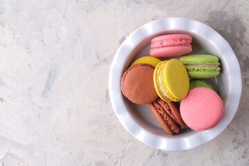 Macaroons on a light background. Sweet French cake, different types of macarons.