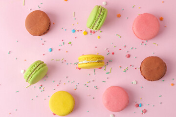 Macaroons on a pink background. Sweet French cake, different types of macarons.