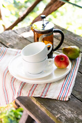 Breakfast serving for two, tea cups and fruits