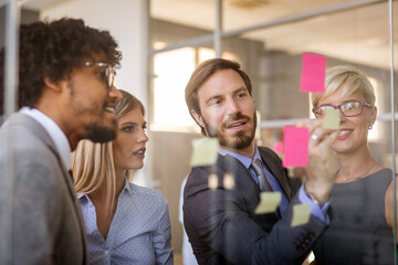 Business team working together on meeting, analyzing financial documents in office