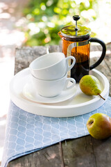 Breakfast serving for two, tea cups and fruits