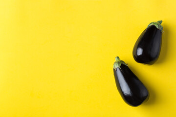 Eggplant or aubergine on yellow background, healthy eating concept