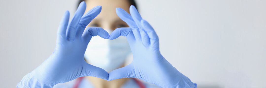 Doctor In Rubber Gloves Showing Heart With Hands Closeup