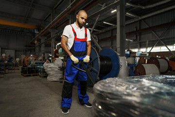 Obraz na płótnie Canvas Portrait of african american male handyman working in an industrial factory