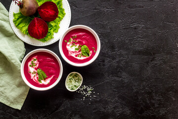 Cream soup made of red beet with raw beet roots