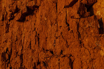 Geology. Desert landscape. Panorama view of the sandstone formation, the rocky cliffs, sand. Background or texture of sandy cliff on the coast, orange limestone