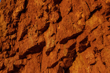 Geology. Desert landscape. Panorama view of the sandstone formation, the rocky cliffs, sand. Background or texture of sandy cliff on the coast, orange limestone
