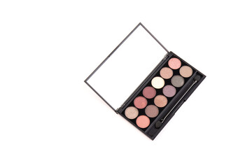 Eyeshadow palette. Black plastic case with twelve powder matte, glitter paint sample in purple, pink, brown, vanilla colors and brush. Top view makeup box isolated on white background