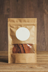 delicious jerky on a wooden background. products in craft packaging. snack for alcohol. macro photo. close-up.
