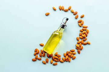 Almond nut oil in glass bottle with almond nuts. Extra virgin essence oil